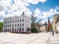 Rynek w Cieplicach Śląskich-Zdroju z zabytkowymi kamienicami i wieżą kościelną.