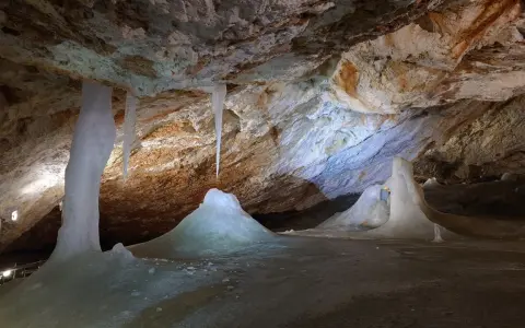 Lodowe formacje i sople wiszące w skalnej jaskini.