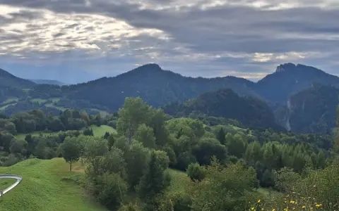 Krajobraz górski z wąwozem, lasami i torami saneczkowymi w tle.